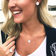 selfie of blonde wearing monogrammed nala jewelry with monogrammed cardigan