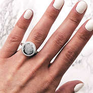 monogrammed silver nala ring on hand with painted fingernails