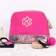 monogrammed glitter and hot pink cosmetic bag with makeup
