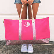 hot pink monogrammed confetti weekender being held by handles