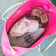 inside hot pink monogrammed confetti weekender bag packed with clothes and shoes