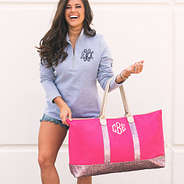 brunette with monogrammed hot pink confetti weekender on arm