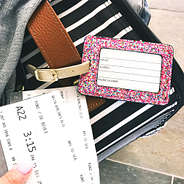 confetti luggage tag attached to suitcase at the airport