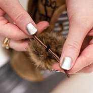 tying pom pom on lace