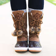 brown pom poms on winter duck boots