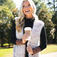 cozy knit vest with black turtleneck and coffee