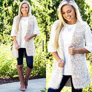 cozy knit vest with dropped hem layering tunic and monogrammed riding boots