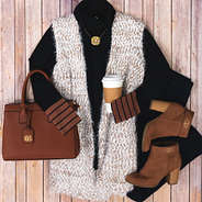 cozy knit vest with black turtleneck and monogrammed purse