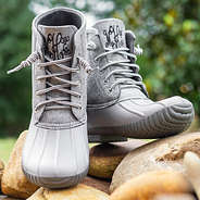 monogrammed gray quilted duck boots on rocks