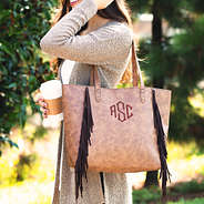 monogrammed fringe tote on shoulder