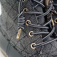 close up of aglet on black herringbone duck boots