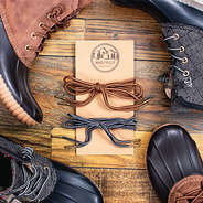 flat lay of laces on card with duck boots