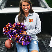 clemson cheerleader wearing clemson pullover sweatshirt