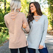 girls with linked arms wearing two way striped tunics on criss cross sides