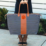 girl holding clemson weekender bag