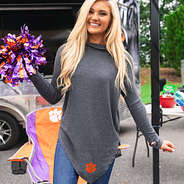 clemson fan at tailgate wearing asymmetrical turtleneck tunic with orange and purple pom poms