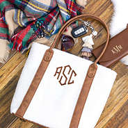 flay lay of sherpa tote bag with monogrammed scarf