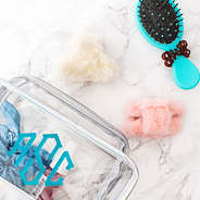 white and pink sherpa hair clips with makeup bag