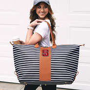 striped nc state weekender bag on shoulder