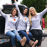 girls on truck tailgate wearing pullover sweatshirts