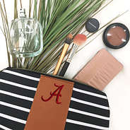 alabama cosmetic bag with makeup coming out of it