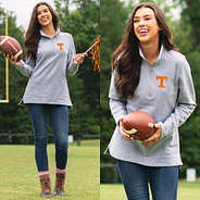 girl on football field wearing tennessee pullover sweatshirt with jeans and duck boots