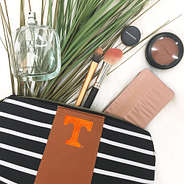 tennessee cosmetic bag with makeup coming out of it