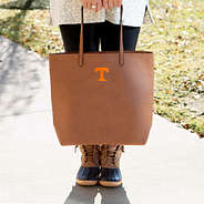 Tennessee Volunteers Basic Tote Bag in Brown holding in front of duck boots