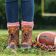 tennessee duck boots with orange socks on football field