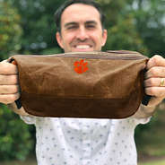 man holding clemson dopp kit - sp23