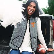 tennessee fan wearing herringbone vest and holding pom pom