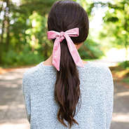 pink velvet bow scrunchie in brunette ponytail