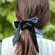 black velvet bow hair tie in brown hair