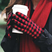 red and black buffalo check gloves holding coffee
