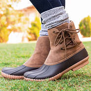 side foot pop of pull on duck boots on grass