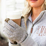 girl holding coffee wearing marbleized knit gloves in brown
