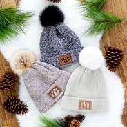 winter pom pom beanies in charcoal, brown, and gray