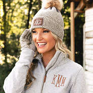 blonde wearing monogrammed brown knit beanie