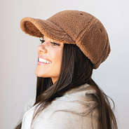 sherpa baseball hat with on brunette wearing quarter zip sweatshirt