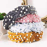 stack of pearl knotted headbands on vanity