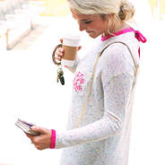 woman checking phone in confetti phone crossbody