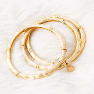 gold bamboo bracelets on fur