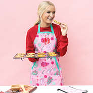girl baking cookies in fun and frosted monogrammed apron