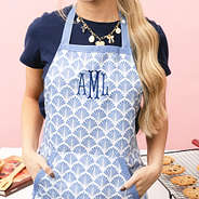 girl wearing monogrammed blue shells apron
