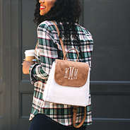 monogrammed sherpa backpack on shoulder with plaid top