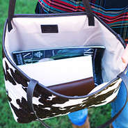 inside cowhide tote with snap flap closure