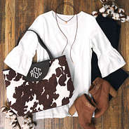 monogrammed cowhide tote bag with bell sleeved top and suede choker