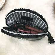 inside of black scalloped cosmetics case