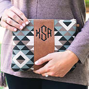 girl holding monogrammed aztec print clutch in hands