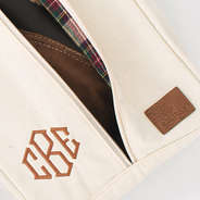 close up of monogram and leather branding on monogrammed travel shoe bag